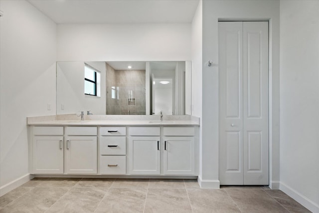 bathroom with vanity and a tile shower