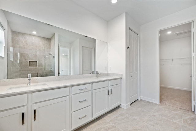 bathroom with vanity and a shower with door