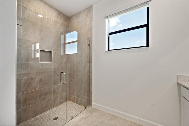 bathroom featuring tile patterned floors, vanity, and a shower with door