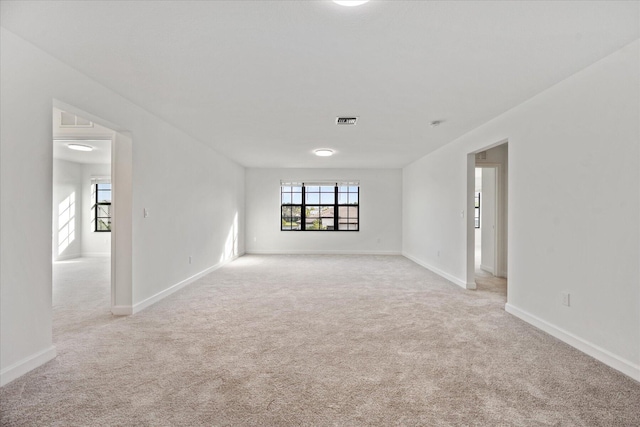 unfurnished room featuring light colored carpet