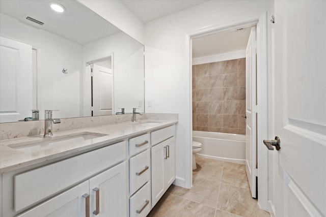 full bathroom featuring vanity, toilet, and tiled shower / bath