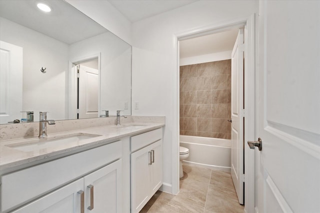 full bathroom with vanity, toilet, and tiled shower / bath combo