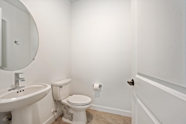 bathroom with sink, tile patterned flooring, and toilet