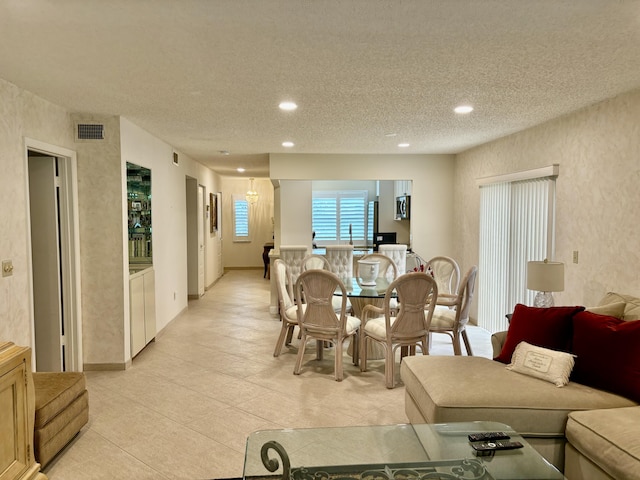 tiled dining room with a textured ceiling