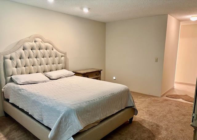 carpeted bedroom featuring a textured ceiling