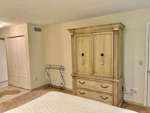 unfurnished bedroom with a textured ceiling, light colored carpet, and a closet