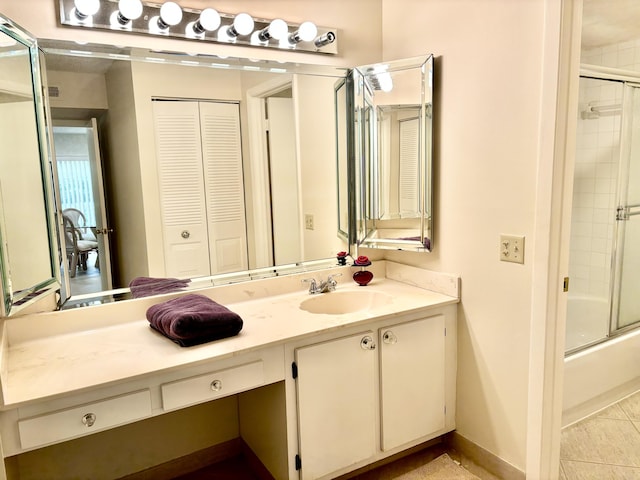 bathroom with enclosed tub / shower combo and vanity