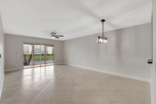 tiled empty room with ceiling fan with notable chandelier