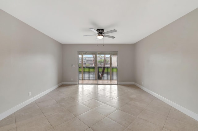 tiled empty room featuring ceiling fan