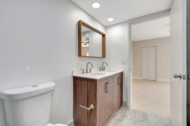 bathroom featuring toilet and vanity