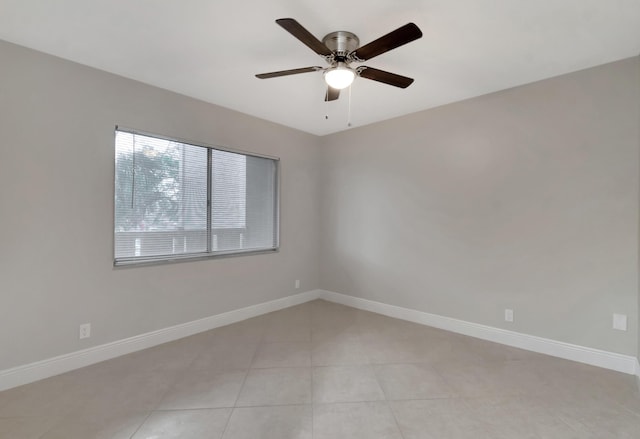 unfurnished room featuring ceiling fan and light tile patterned floors