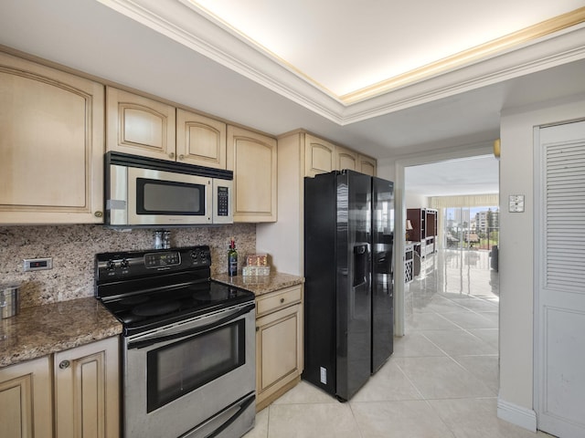 kitchen with a tray ceiling, stainless steel appliances, decorative backsplash, ornamental molding, and dark stone counters