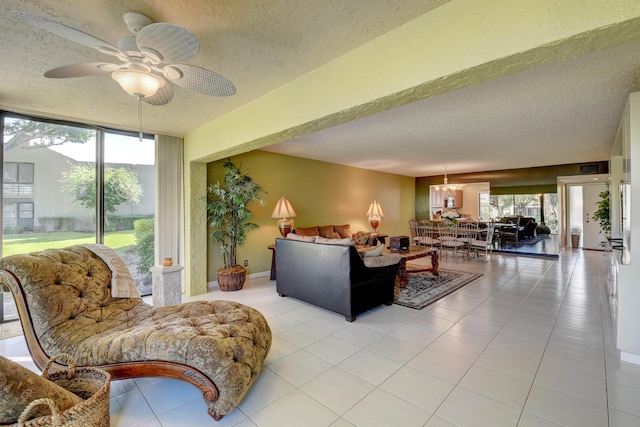 tiled living room featuring ceiling fan with notable chandelier and a textured ceiling