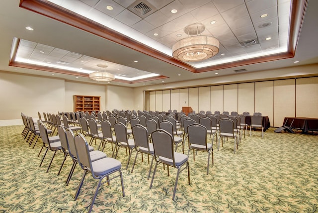 carpeted cinema featuring an inviting chandelier and a tray ceiling