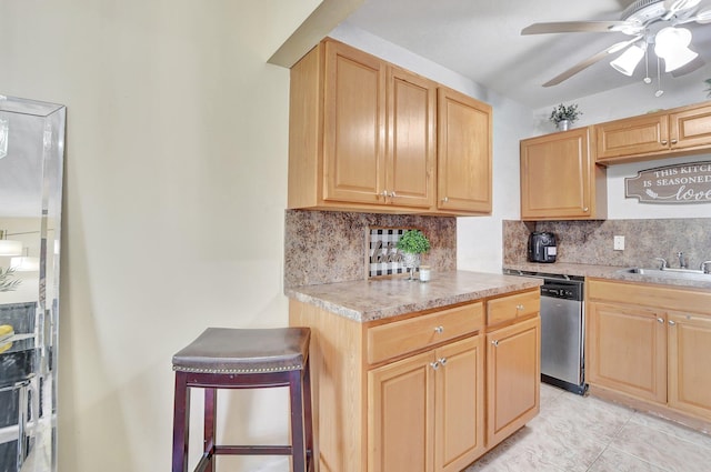 kitchen featuring dishwasher, ceiling fan, tasteful backsplash, sink, and light tile floors