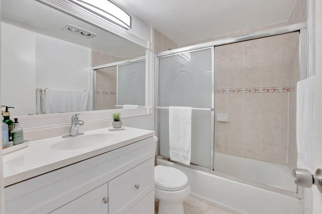 full bathroom featuring tile flooring, bath / shower combo with glass door, toilet, and large vanity