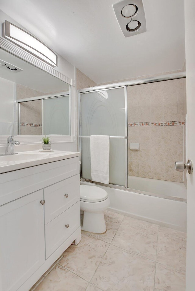 full bathroom featuring combined bath / shower with glass door, vanity, toilet, and tile floors