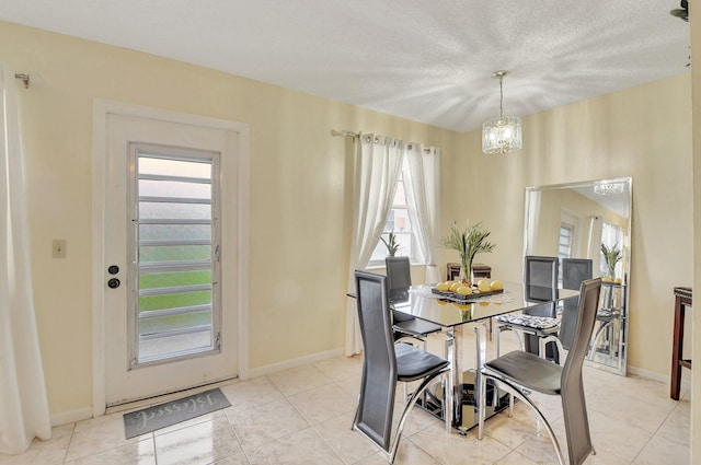 tiled dining room with a healthy amount of sunlight and a chandelier