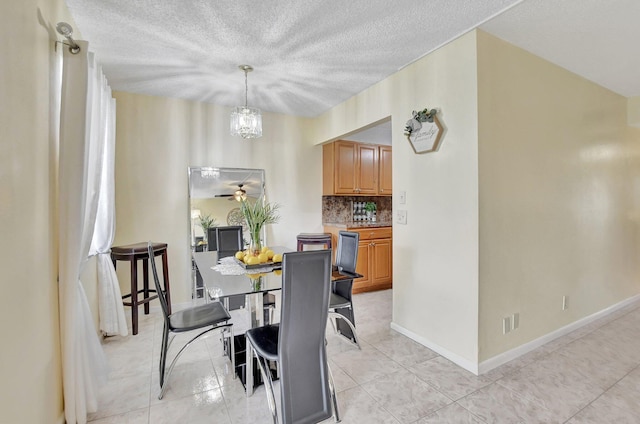 dining room featuring a chandelier, a textured ceiling, and light tile floors