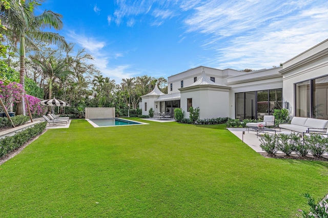 view of yard featuring an outdoor pool and a patio