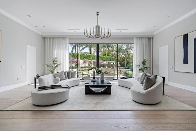 living room with crown molding, a notable chandelier, and light hardwood / wood-style flooring