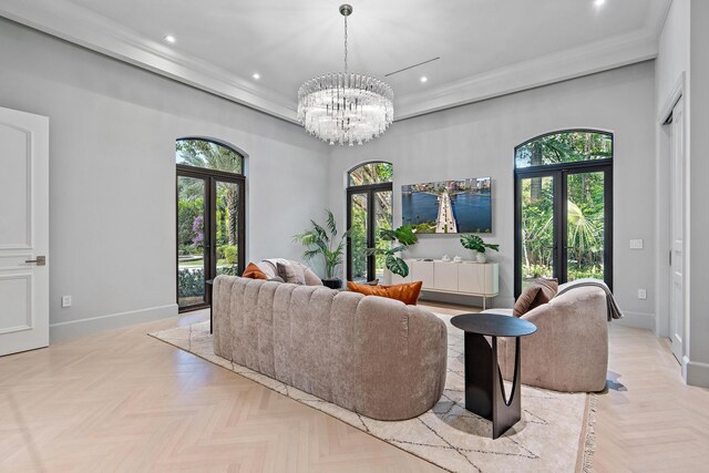 living room featuring ornamental molding, a chandelier, and light parquet flooring