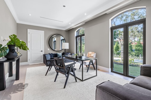 dining room with plenty of natural light, light hardwood / wood-style floors, crown molding, and french doors