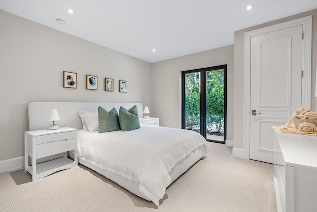 bedroom featuring light carpet, french doors, and access to outside