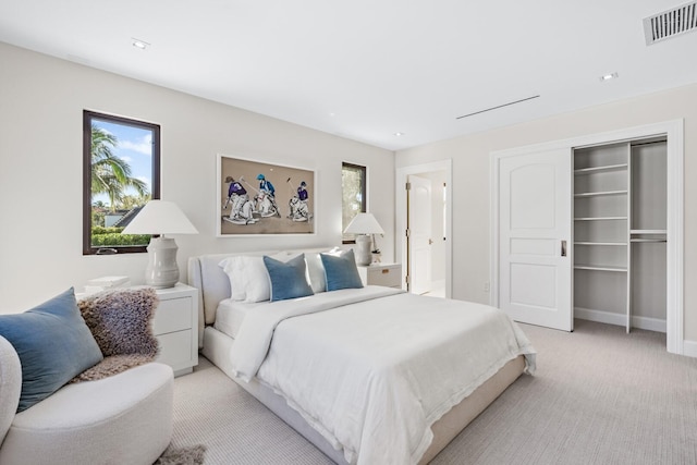 bedroom featuring light colored carpet and a closet