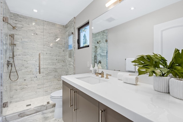 bathroom with walk in shower, vanity, and toilet