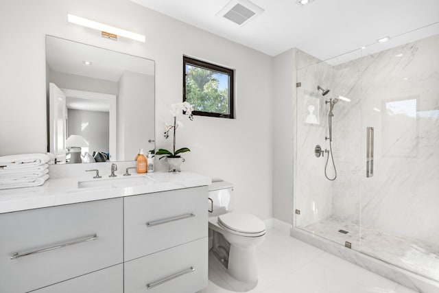 bathroom with a shower with shower door, tile flooring, vanity, and toilet