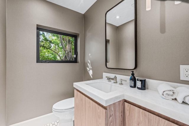 bathroom with vanity, toilet, and tile floors