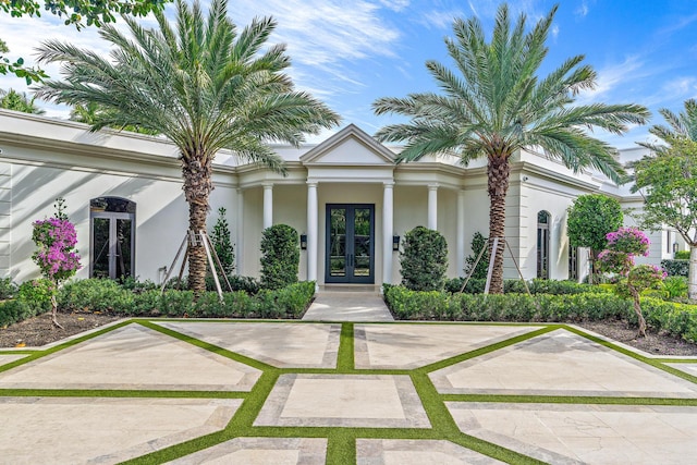 greek revival inspired property featuring french doors