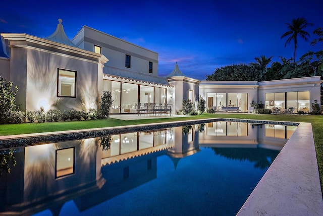 view of swimming pool featuring a patio and a yard