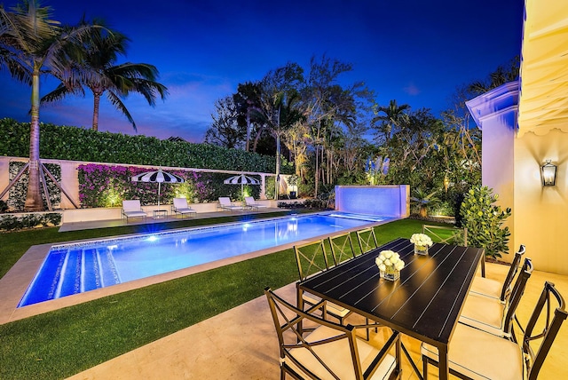 view of pool featuring a patio and a lawn