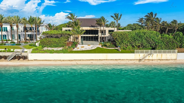 view of pool featuring a water view and a beach view