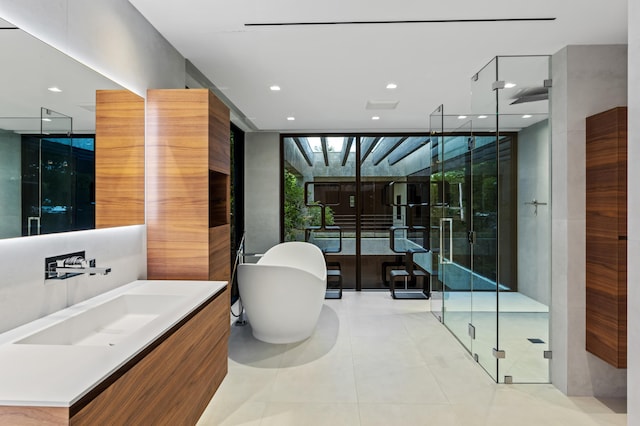 bathroom with vanity, tile patterned flooring, a wall of windows, and independent shower and bath