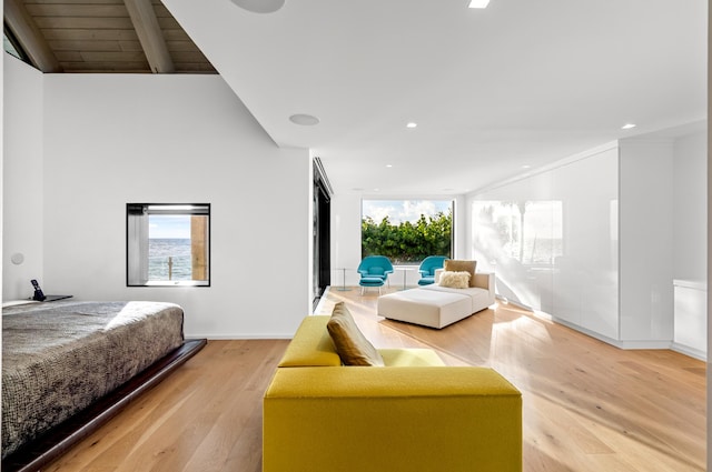 bedroom featuring lofted ceiling and light wood-type flooring