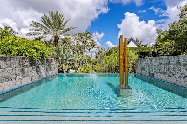 view of swimming pool featuring pool water feature