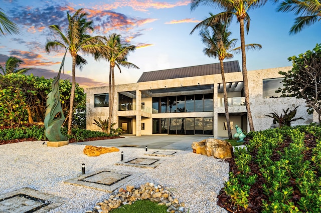 view of outdoor building at dusk