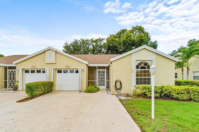 ranch-style home featuring a garage and a front lawn