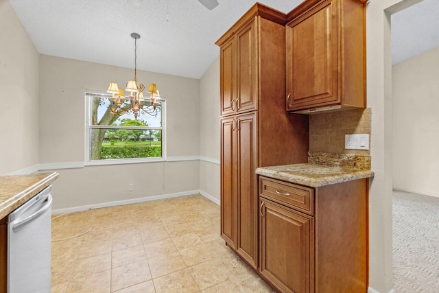 kitchen with dishwashing machine, an inviting chandelier, decorative light fixtures, decorative backsplash, and light tile patterned floors