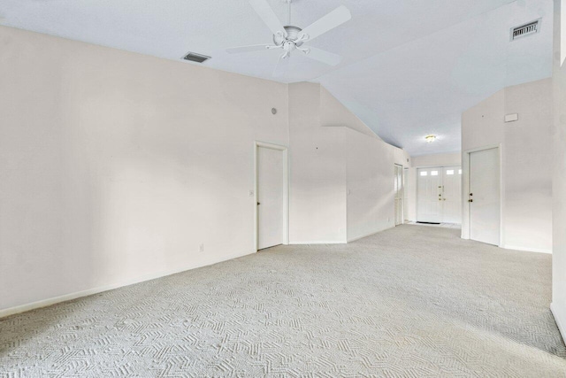 carpeted empty room with ceiling fan and vaulted ceiling