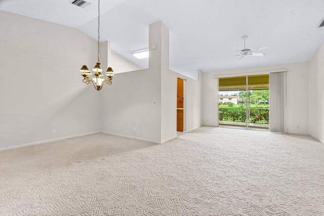 unfurnished living room featuring carpet, ceiling fan with notable chandelier, and vaulted ceiling