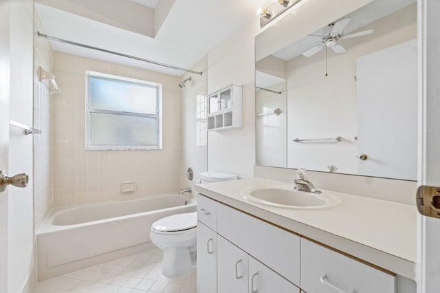 full bathroom featuring tile patterned floors, vanity, ceiling fan, toilet, and tiled shower / bath