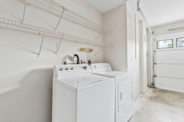 washroom with separate washer and dryer and a textured ceiling