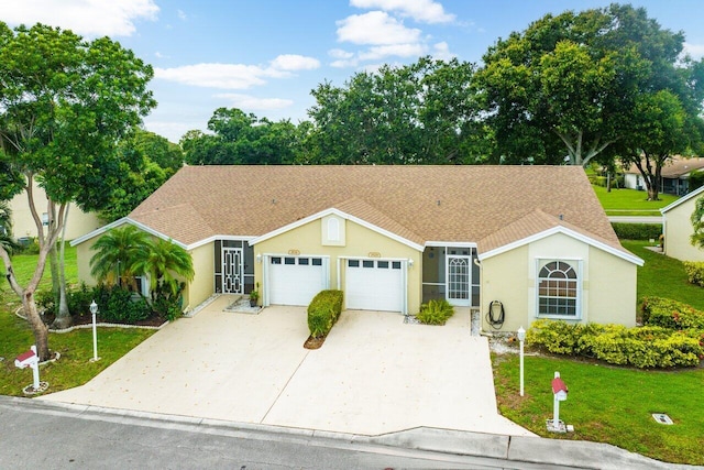 view of front of house with a garage and a front lawn