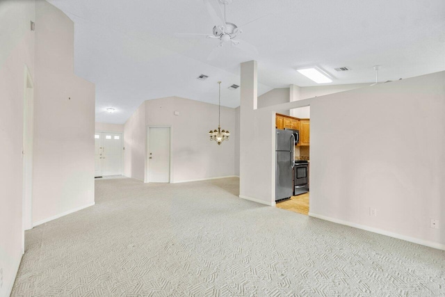 unfurnished room with ceiling fan with notable chandelier, light colored carpet, and vaulted ceiling