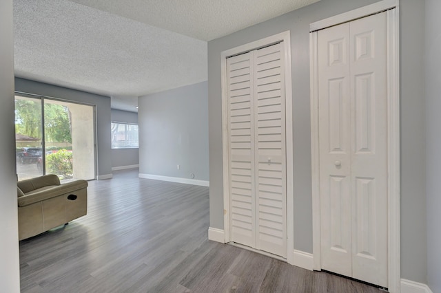 interior space with a textured ceiling and light hardwood / wood-style floors