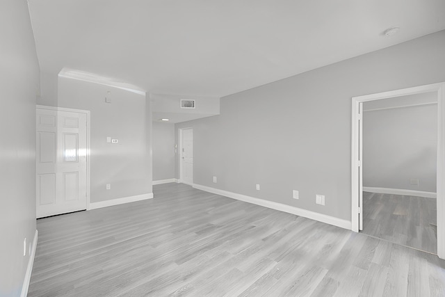 unfurnished room with light hardwood / wood-style floors